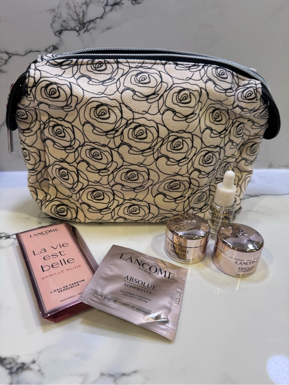 NWOT Lancome Floral Canvas Cosmetic Bag in Cream and Black with skincare minis